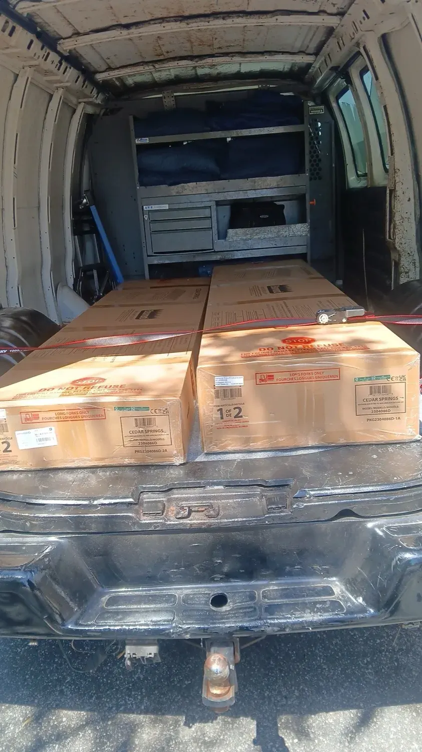 Large boxed items secured inside the van for a careful delivery