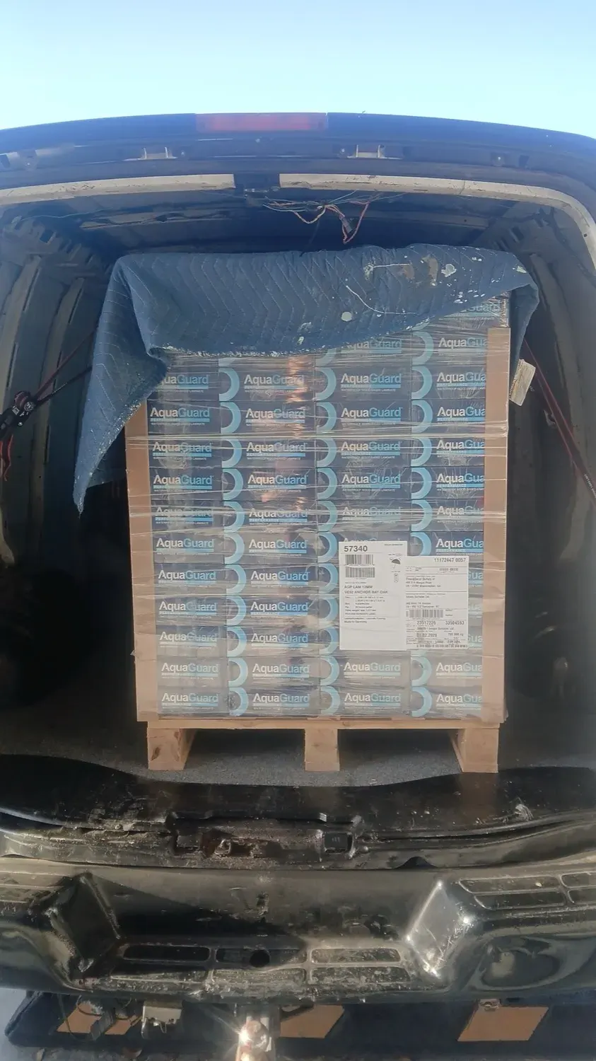 A pallet of AquaGuard flooring loaded in the van for a Tampa Bay delivery